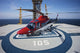 AgustaWestland AW109E helicopter parked on an oil rig in the Gulf of Mexico poster print.