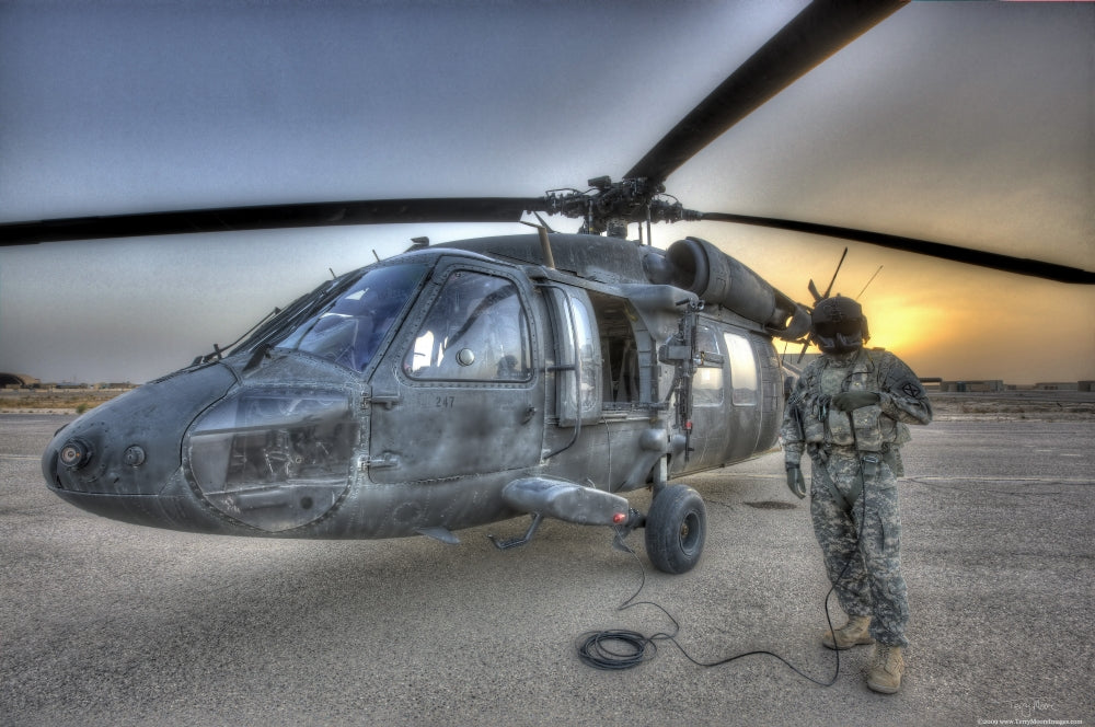 High dynamic range image of a door gunner beside a UH-60 Black Hawk helicopter in Tikrit, Iraq.