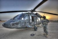 High dynamic range image of a door gunner beside a UH-60 Black Hawk helicopter in Tikrit, Iraq.