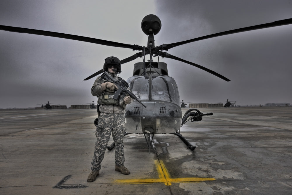 Pilot in front of OH-58D Kiowa helicopter high dynamic range image poster.