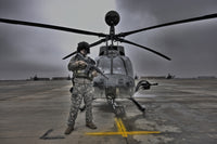 Pilot in front of OH-58D Kiowa helicopter high dynamic range image poster.