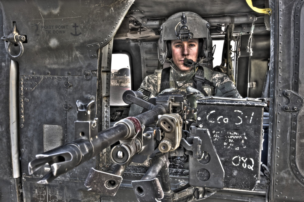 UH-60 Black Hawk door gunner operating an M240B machine gun in Tikrit, Iraq poster print.