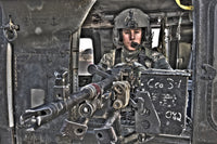 UH-60 Black Hawk door gunner operating an M240B machine gun in Tikrit, Iraq poster print.