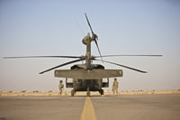 UH-60 Black Hawk flight crew members poster print featuring fire extinguishers during startup in Tikrit, Iraq.