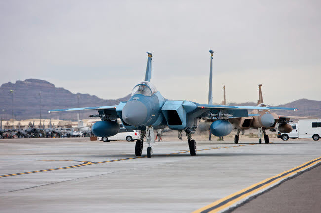 F-15C Eagles Taxiing Poster Print by Terry Moore showcasing military aviation.