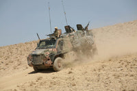 Dutch military vehicle driving down a dirt hill in Afghanistan poster print
