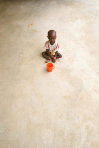 Poster print of a malnourished child in a clinic during the 2008 famine in Nigeria