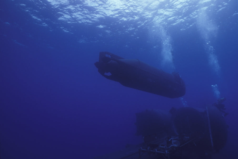 A SEAL Delivery Vehicle approaches the Dry Deck Shelter aboard USS Kamehameha poster print.