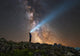 Poster print of a man shining a flashlight on the Milky Way from Lago-Naki plateau in Russia.