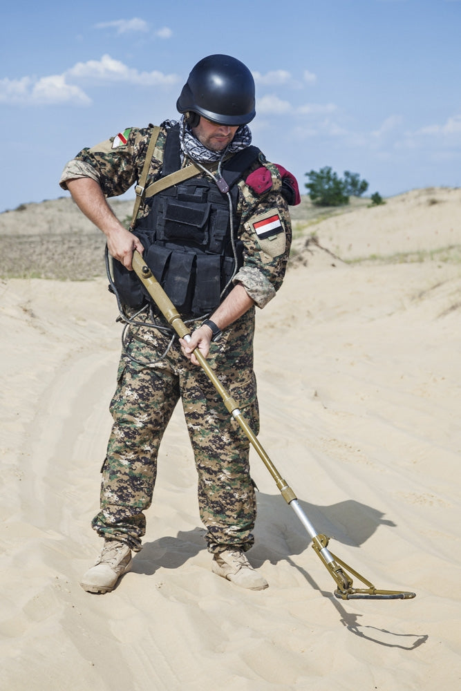 Iraqi soldier in the desert with Army metal detector poster print.