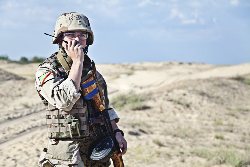 Iraqi soldier in the desert with portable radio poster print by Oleg Zabielin