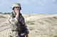 Iraqi soldier in the desert with portable radio poster print by Oleg Zabielin