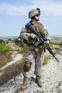 Close-up photo of U.S. Marine holding his rifle, by Oleg Zabielin.