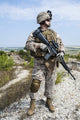 Close-up photo of U.S. Marine holding his rifle, by Oleg Zabielin.