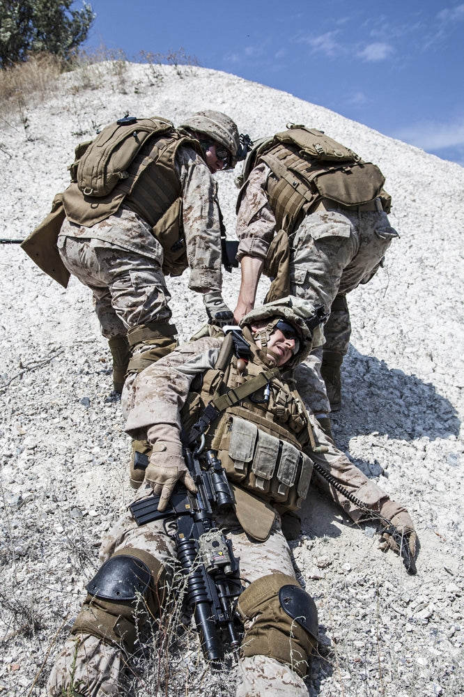 U.S. Marines evacuating injured soldier in the mountains poster print by Oleg Zabielin.