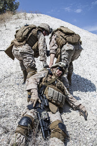 U.S. Marines evacuating injured soldier in the mountains poster print by Oleg Zabielin.