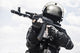 Spec Ops soldier in black uniform and face mask with rifle poster print.
