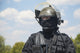 Spec Ops soldier in black uniform and face mask with rifle poster print by Oleg Zabielin.