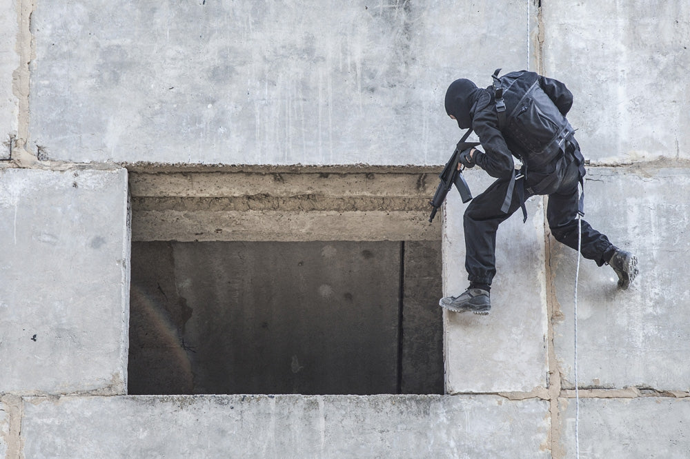 Spec Ops soldier in face mask during rope exercises with weapons poster print.