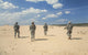 Team of United States Airborne Infantry Men Patrolling the Desert Poster Print
