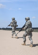 Poster print of United States airborne infantrymen patrolling the desert by Oleg Zabielin.