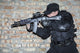 Special Forces Operator in black uniform and bulletproof vest poster print.