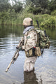 Navy SEAL Team member crossing the river with weapons poster print.