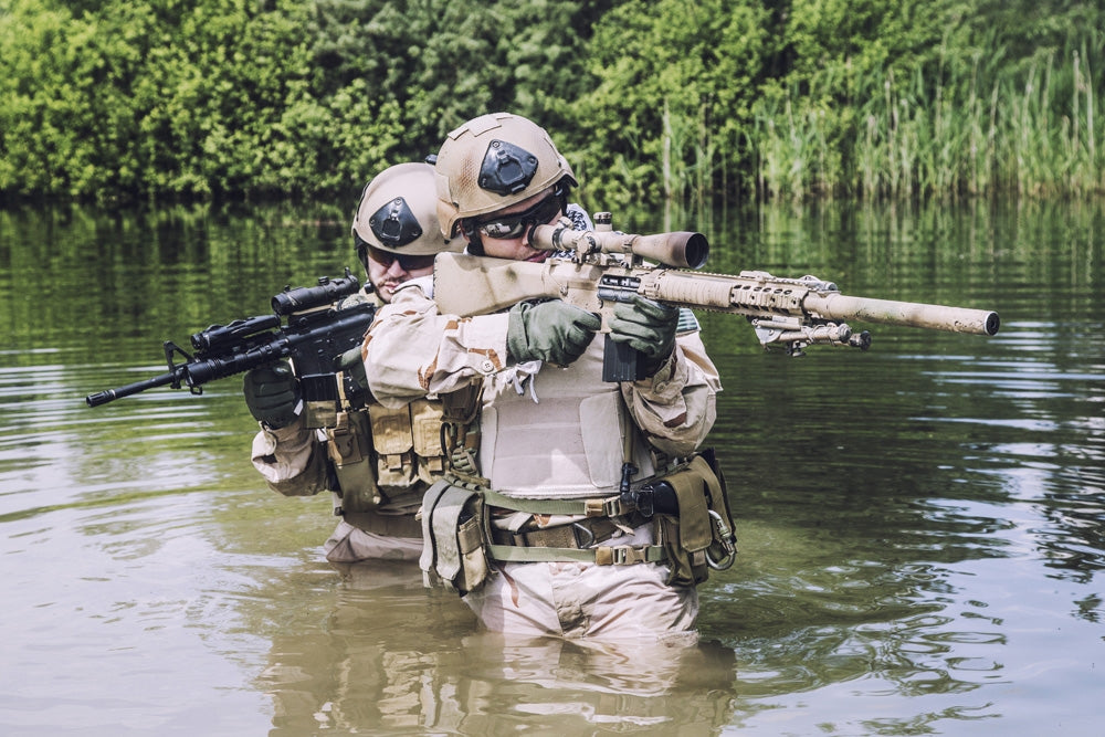 Navy SEALs crossing the river with weapons poster print by Oleg Zabielin
