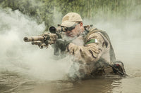 Navy SEAL team member crossing a river with weapons poster print.