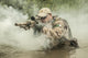 Navy SEAL team member crossing a river with weapons poster print.