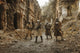 Post-apocalyptic survivors in tatters and gas masks on the ruins of a destroyed city artwork by Oleg Zabielin.