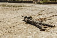 Young male sniper in camouflage with gun in the desert poster print.