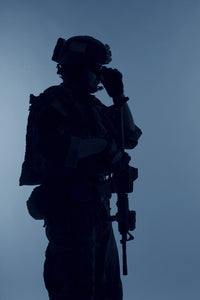Silhouette of a U.S. Marine Corps Marsoc raider with weapon on blue background.