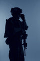 Silhouette of a U.S. Marine Corps Marsoc raider with weapon on blue background.