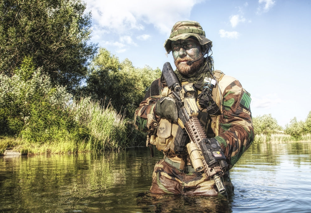 Bearded soldier of special forces in action during a river raid in jungle terrain poster print.