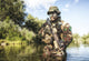 Bearded soldier of special forces in action during a river raid in jungle terrain poster print.