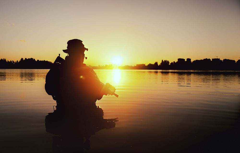 Silhouette of special forces soldier during a river raid in the jungle poster print.