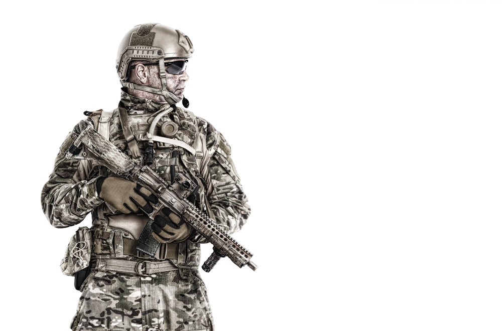 Half-length portrait of a special forces soldier in field uniform with weapon.