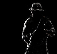 Bearded Special Forces soldier portrait in backlight, military art print.