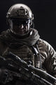 Contour backlight portrait of a special forces soldier in uniform with weapon.