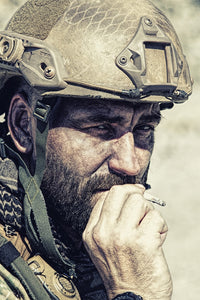 Close-up poster print of a soldier smoking in the desert by Oleg Zabielin.