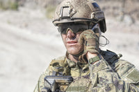 Close-up shot of soldier on phone in the desert poster print by Oleg Zabielin.
