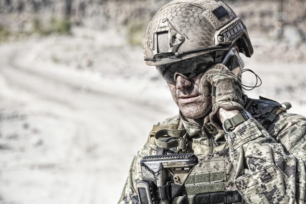 Close-up portrait of soldier on phone in desert, poster print by Oleg Zabielin