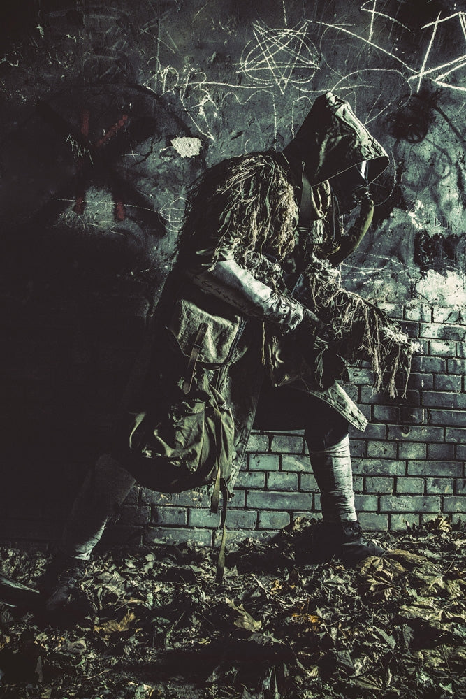 Post apocalypse survivor in gas mask and ghillie cape sneaking in underground tunnel poster print.