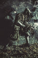Post apocalypse survivor in gas mask and ghillie cape sneaking in underground tunnel poster print.