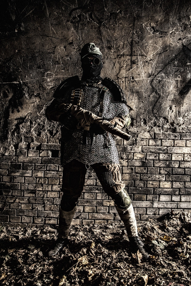 Post-apocalyptic soldier with handmade gun and body armor in an abandoned bunker poster print by Oleg Zabielin.