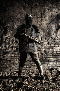 Post-apocalyptic soldier with handmade gun and body armor in an abandoned bunker poster print by Oleg Zabielin.