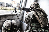 Machine gunner shooting out of a window in a ruined building during a firefight poster print.