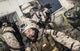 Special Forces team leader poster print featuring tactical radio communication under enemy fire.
