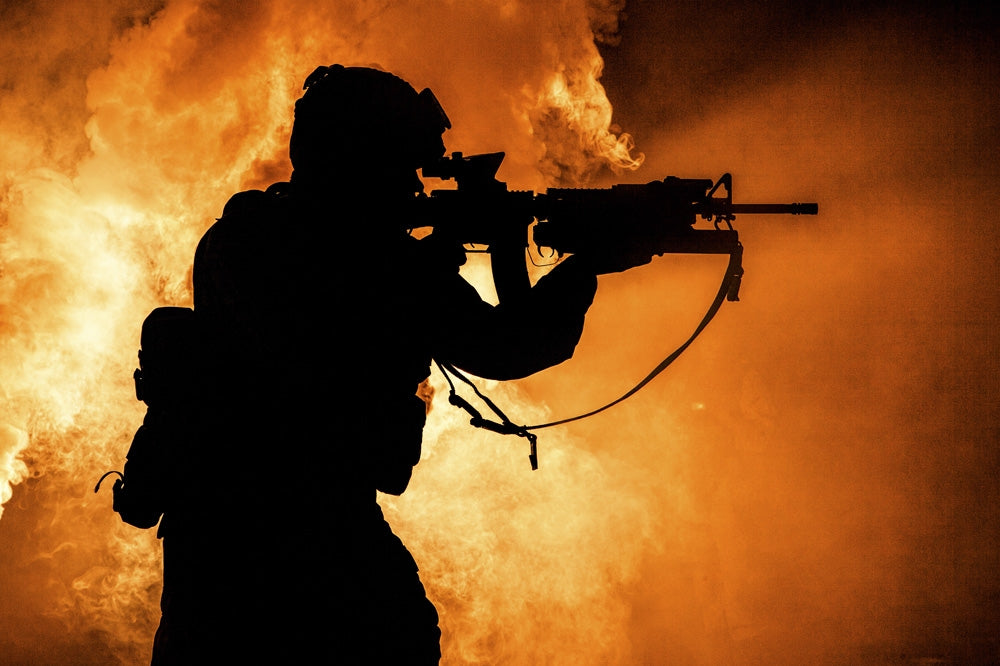 Silhouette of a modern infantry soldier with an assault rifle on a colored background poster print.